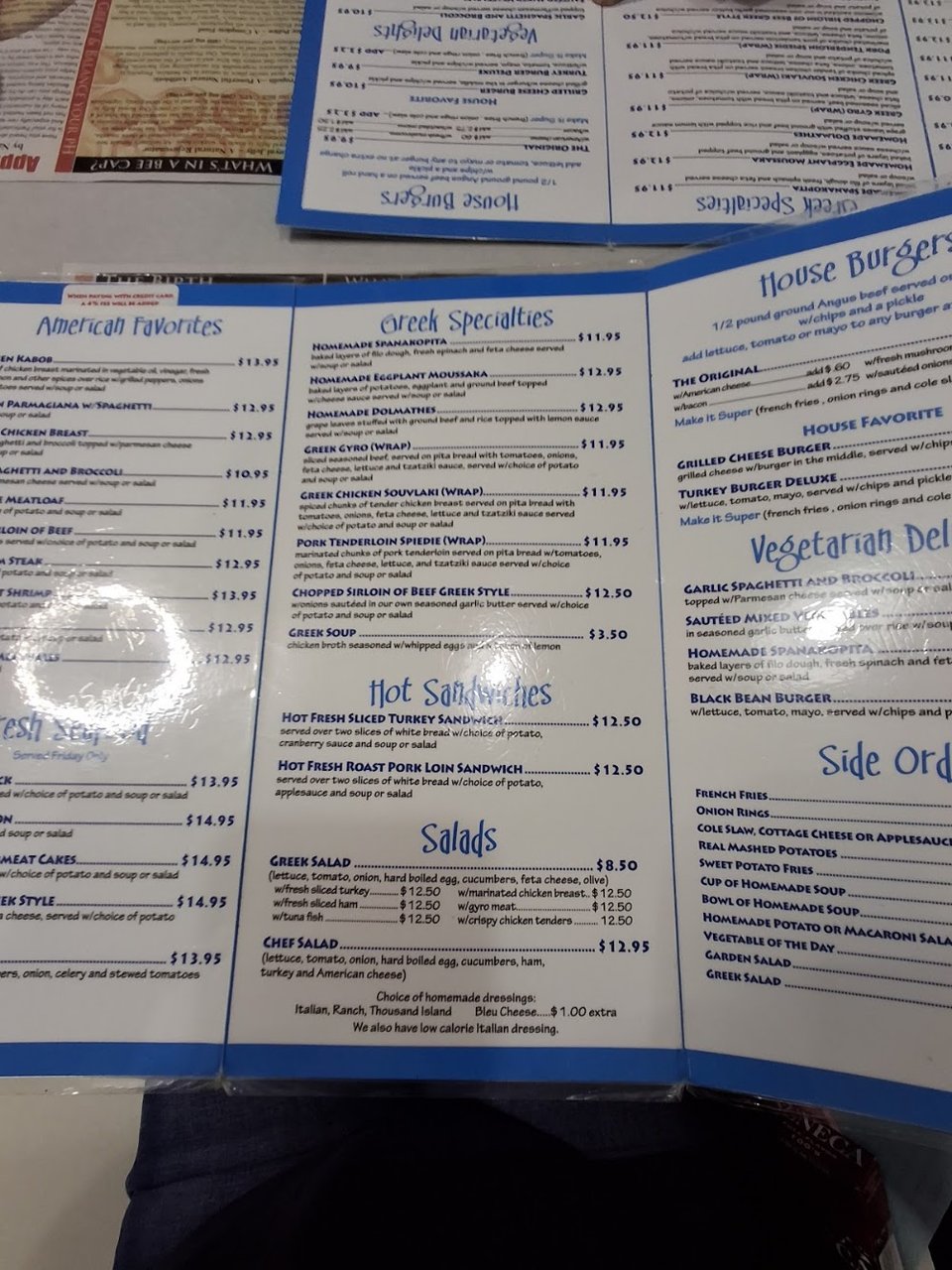 Menu page with Greek specialties and breakfast items.